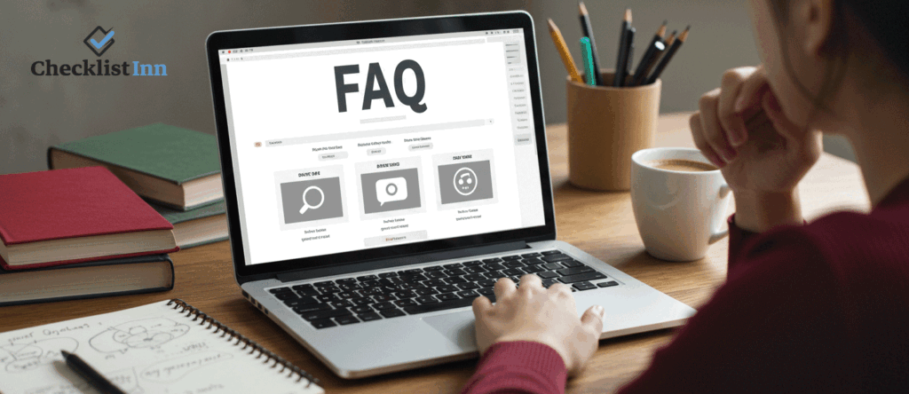Person at a desk looking at a laptop with a blank FAQ layout, surrounded by books and a notebook.